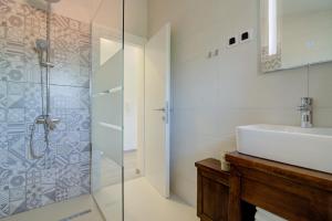 a bathroom with a sink and a shower at VisumApartments in Senj +38 photos