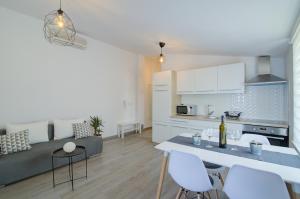 a kitchen and living room with a table and chairs at VisumApartments in Senj