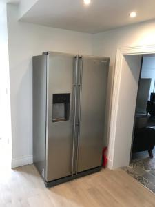 a large stainless steel refrigerator in a room at Mary Ann's Ballyheigue Cottage in Tralee