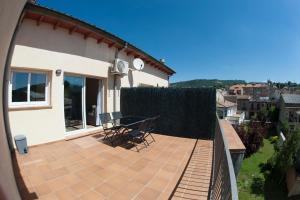 a balcony of a house with a table and chairs at Apartament Can Jaumató in Sant Quirze de Besora