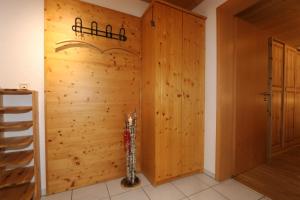 a room with a wooden wall with a fire extinguisher at Ferienwohnungen Panoramablick in Bernau im Schwarzwald