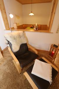 a living room with a chair and a table at Ferienwohnungen Panoramablick in Bernau im Schwarzwald