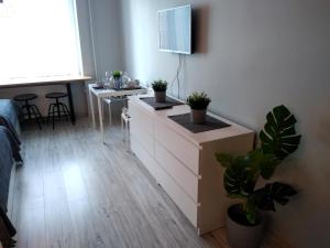 sypialnia z komodą z doniczkami w obiekcie Apartament Be Happy Nr 2 w mieście Gdynia