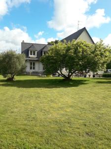 a large house with trees in the yard at Chambre dans jolie demeure in Gouesnou
