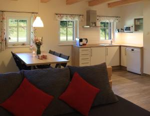 a kitchen and living room with a couch and a table at Chalupa U první skály in Chřibská