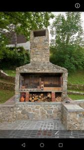 a stone oven with logs inside of it at Apartment Luskino 22 in Matulji