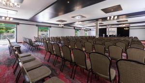 a row of chairs in a room with a stage at Imperia Hotel & Suites Saint-Eustache in Saint-Eustache +26 photos