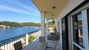 a balcony with a view of the water at ARIA in Sumartin