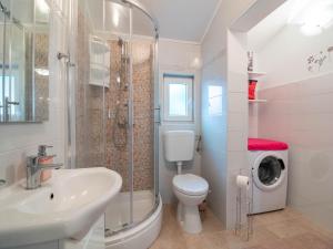 a bathroom with a sink and a toilet and a shower at Apartman Arijana 3 in Medulin +16 photos