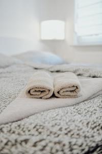 a pair of towels sitting on top of a bed at Apartman M5 in Đakovo