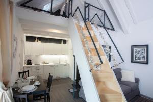a staircase in a room with a table and a kitchen at Lodge Diana & Room Sweet 26 in Bled