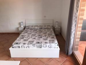 a bedroom with a bed with a white bed frame at TERRAZZA SUL MARE wifi e piscina in Nebida