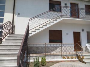 a set of stairs leading to a building with a stair case at 5 Palme in Terzo dʼ Aquiléia