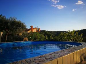a swimming pool in front of a house at VILLA ČEH in Gabrovica pri Črnem Kalu