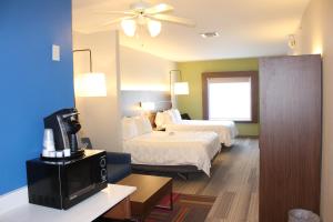 a hotel room with two beds and a television at Holiday Inn Express Hotel & Suites Mansfield, an IHG Hotel in Mansfield
