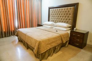 
a hotel room with a bed and a dresser at City View Hotel & Restaurant in Lahore
