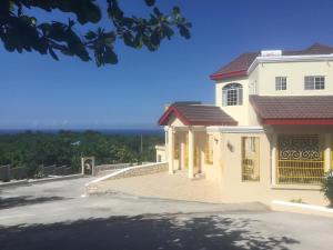 a white house with a view of the ocean at Cool Breeze Discovery Bay in Discovery Bay