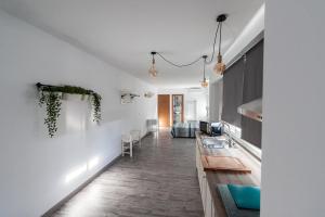 a living room with white walls and a dining room at Apartamento Loft Sopranis in Cádiz