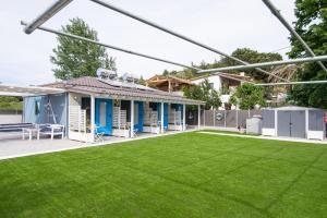 a house with a yard with green grass at Nautical Toroni Rooms in Toroni
