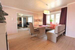 a living room with a table and a dining room at Mama Roserl in Hauzenberg