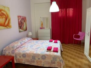 a bedroom with a bed and a red curtain at Sabbie d'oro in Gela