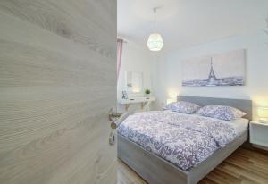 a bedroom with a bed and a picture of the eiffel tower at Josipa & Jelena Apartment in Senj