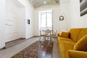 a living room with a couch and a table at Casa Marene Ortigia in Siracusa