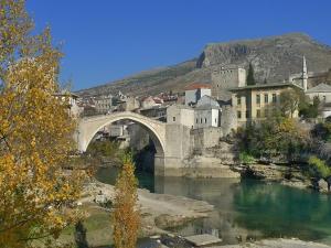 a bridge over a river next to a city at Guesthouse Liska in Mostar