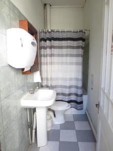 a bathroom with a sink and a toilet at Hostal Plaza Londres 77 in Santiago