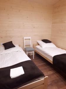 A bed or beds in a room at Sarzynówka pod Sosną