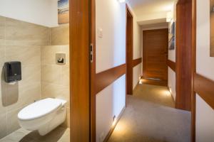 a bathroom with a toilet and a door open at Rancho Willa & Restaurant in Rewal