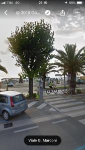 a person riding a bike in a parking lot at Alba Adriatica Olimpica in Alba Adriatica