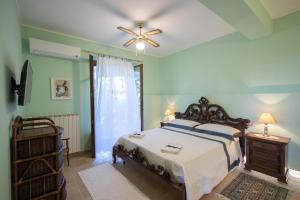 a bedroom with a bed and a ceiling fan at Agriturismo Isola Dei Calanchi - Guest House in Atri