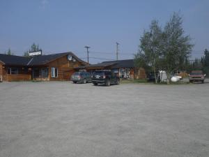 a bus is parked in front of a house at Alcan Motor Inn in Haines Junction