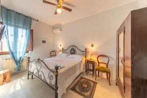 a bedroom with a bed and a ceiling fan at Agriturismo Isola Dei Calanchi - Guest House in Atri