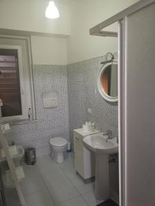 ein Badezimmer mit Waschbecken, Toilette und Spiegel in der Unterkunft Centrum Rooms in Cagliari + 48 Fotos