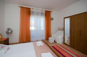 a bedroom with a bed and a large window at Apartment Milja in Banjol