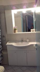 a bathroom with a white sink and a mirror at Seaside Villa for 6 people - Alykes Beach in Dhimínion