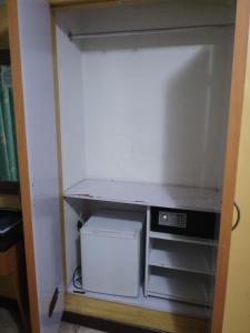 a closet with a desk and a computer in it at Hotel El Limón in Caracas