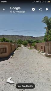 an empty road with a sign in the middle at Hostel Casa de Familia in Humahuaca