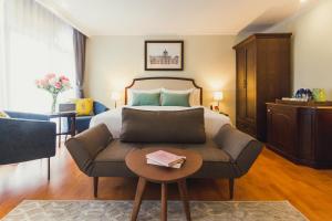 曼谷Daraya Boutique Hotel的一间酒店房间，里面有一张床和一张沙发