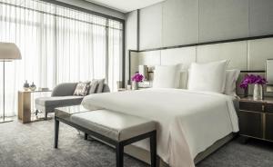 a hotel room with two beds and a large window at Four Seasons Hotel Kuala Lumpur in Kuala Lumpur
