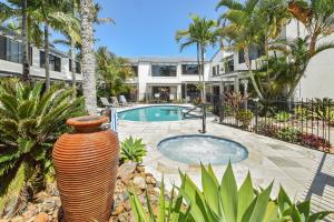 a large vase sitting next to a swimming pool at Noosa Place Resort in Noosaville