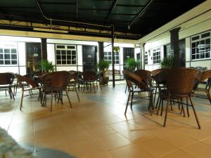 a group of chairs and tables on a patio at Darulmakmur Chalet in Cameron Highlands
