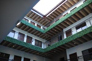 een leeg gebouw met planten op de balkons bij SureStay Plus Hotel by Best Western AC LUXE Angeles City in Angeles