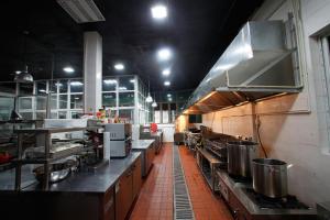 a large kitchen with lots of counters and appliances at Aoting Garden Hotel in Chengdu