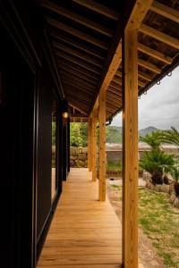 a wooden walkway leading to a house at Okune in Goto