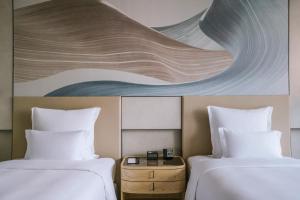 Postel nebo postele na pokoji v ubytování Pullman Shanghai Qingpu Excellence