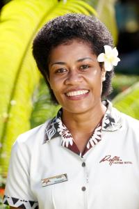 
a woman in a pink dress smiling for the camera at Fiji Gateway Hotel in Nadi
