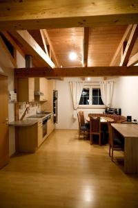 una cucina e una sala da pranzo con soffitti in legno e tavolo di Haus Alpengluehn a Iselsberg Altre 30 foto